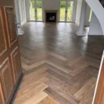 Oak herringbone in a formal room with French doors