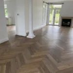 Oak herringbone in a period living room with a column and fireplace