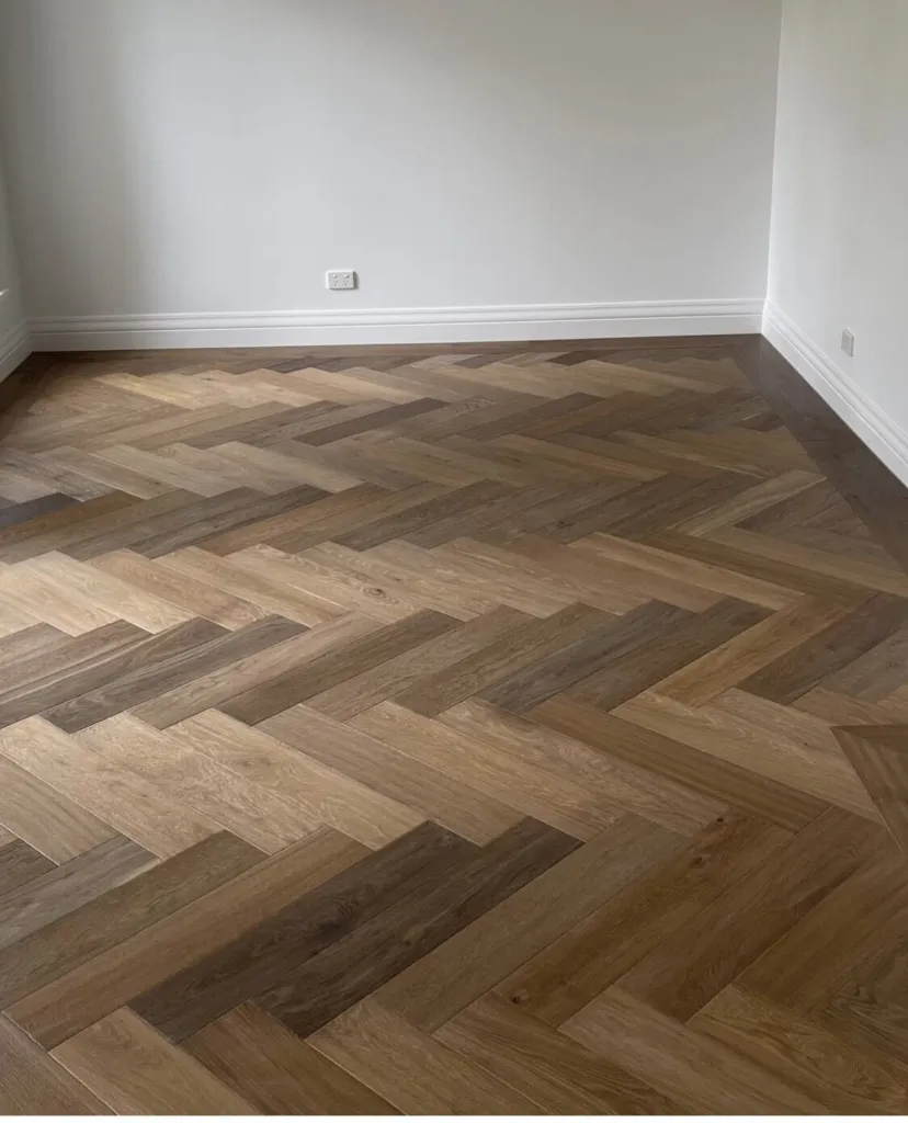 Oak herringbone parquetry in a freshly finished empty room