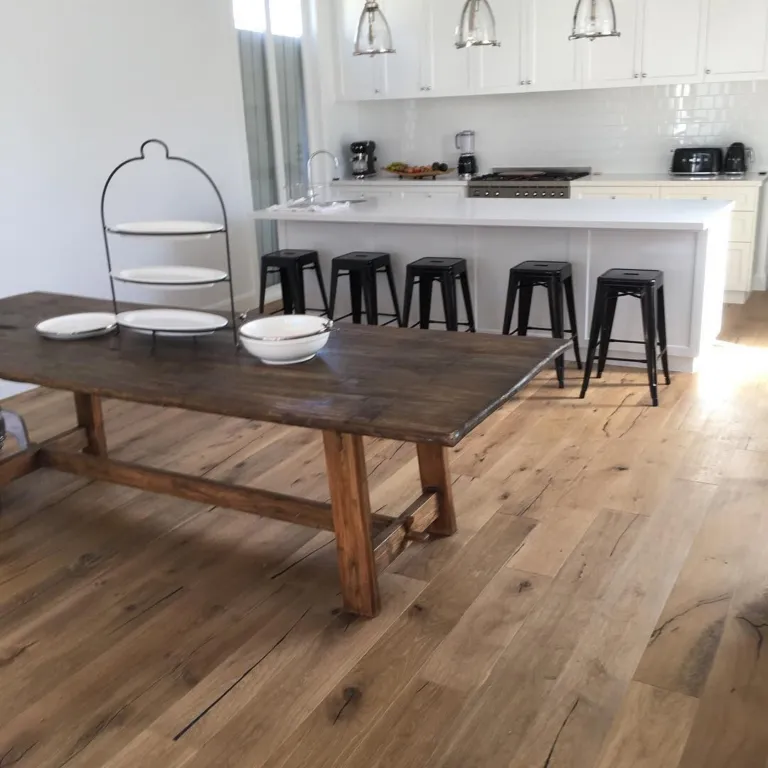 Natural wash oak under a rustic timber dining table