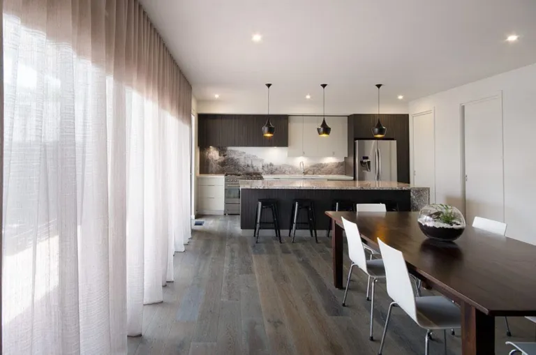 Grey oak floor in a dining and kitchen area with sheer curtains