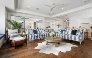Toran Reclaimed Oak in a living room with striped sofas and a cowhide rug