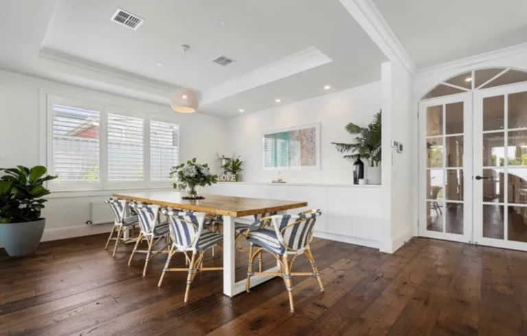 Toran Reclaimed Oak in a dining room with striped chairs and arched French doors