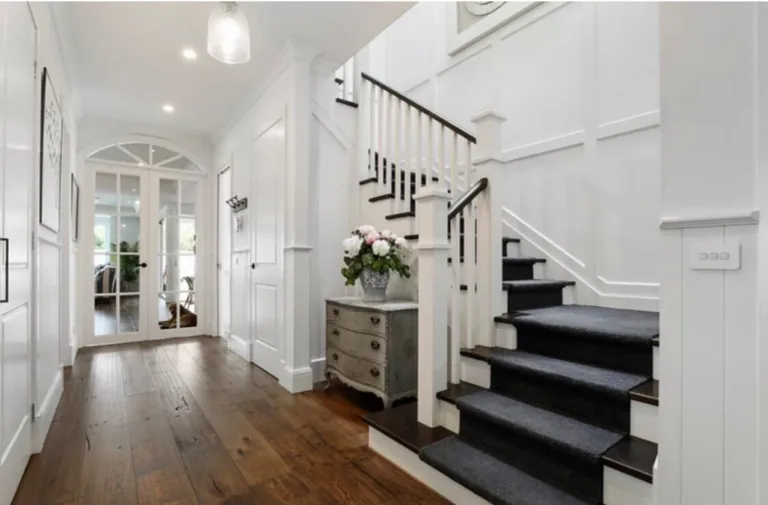 Toran Reclaimed Oak hallway beside a white staircase with a dark runner