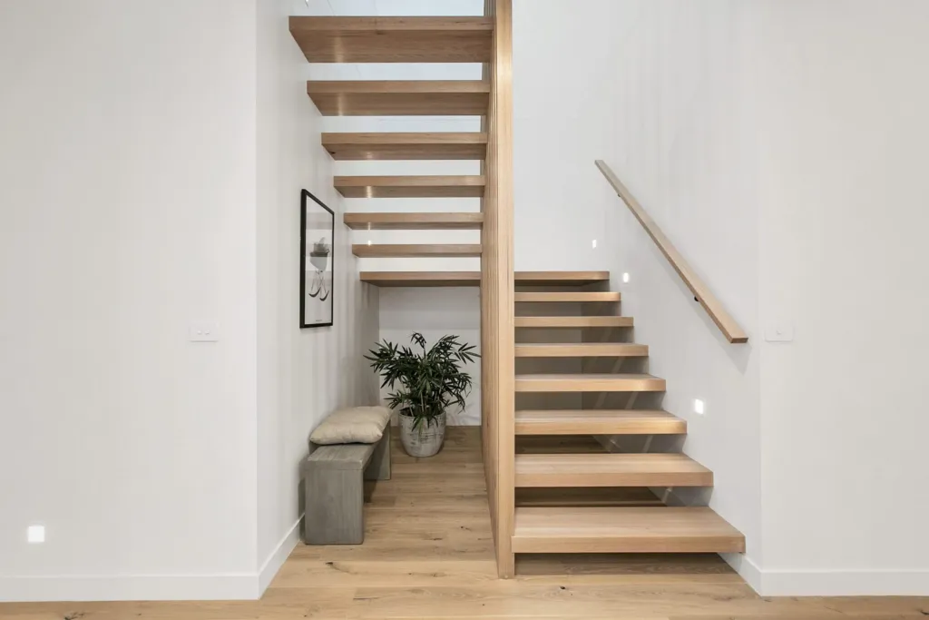 Floating oak staircase in a bright entry