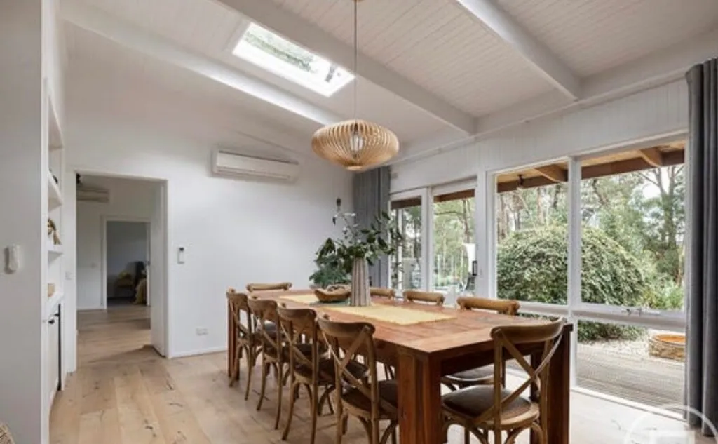 Coastal Vienna Oak under a long dining table beside garden windows