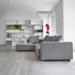 Grey oak floor in a living room with a grey sofa