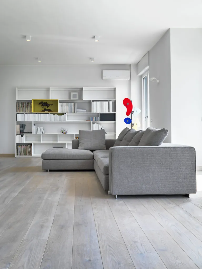 Grey oak floor in a living room with a grey sofa