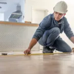Installer measuring a timber floor