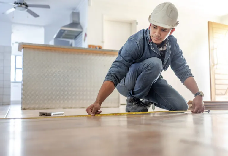 Installer measuring a timber floor