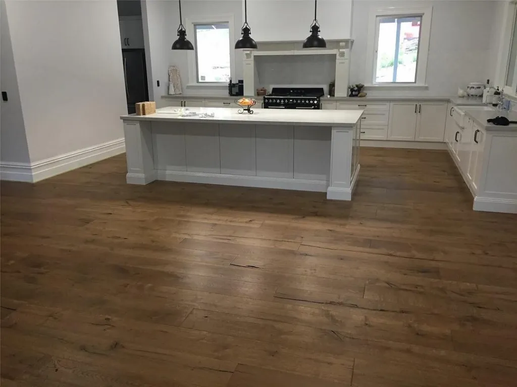 Wide French oak boards in a kitchen with a white island