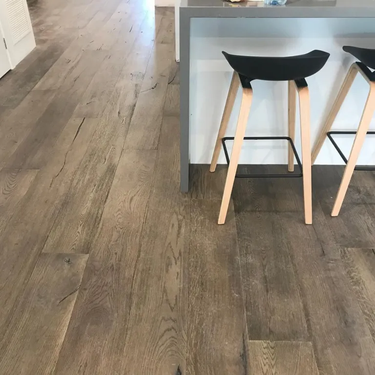 Close view of rustic grey-brown oak boards under kitchen stools