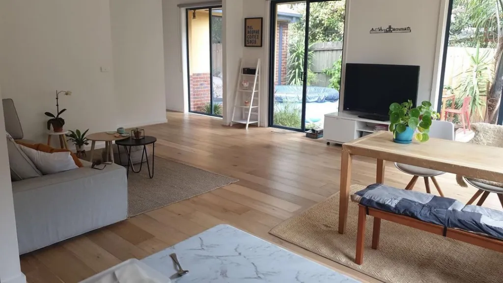 Light oak through a relaxed living and dining room