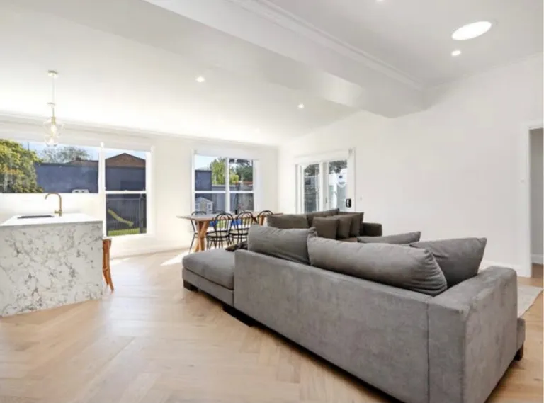 Vermont Oak herringbone floor in a lounge with dining beyond