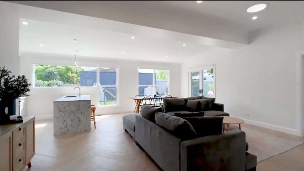 Vermont Oak herringbone running through an open-plan living room to the kitchen