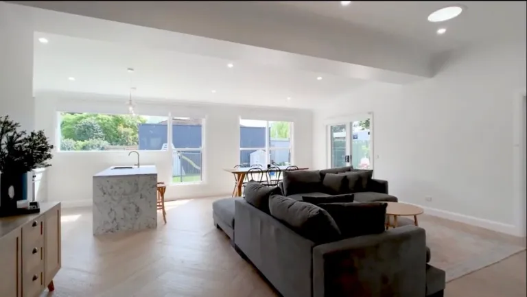Vermont Oak herringbone running through an open-plan living room to the kitchen